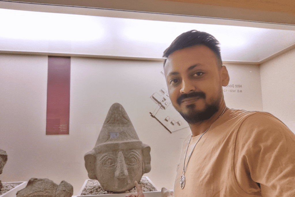 Akash standing in front of the Ancient Hittite God statue at the Bogazkale Museum