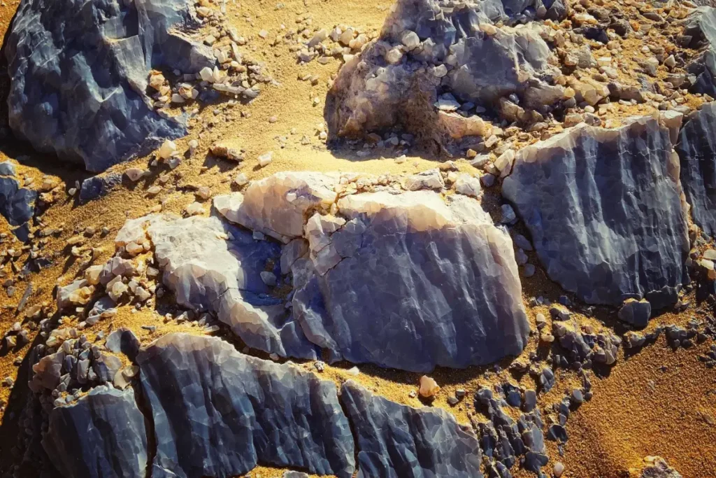 A close-up view of weathered, geometric calcite or quartz crystal formations sparkling in the desert sun.