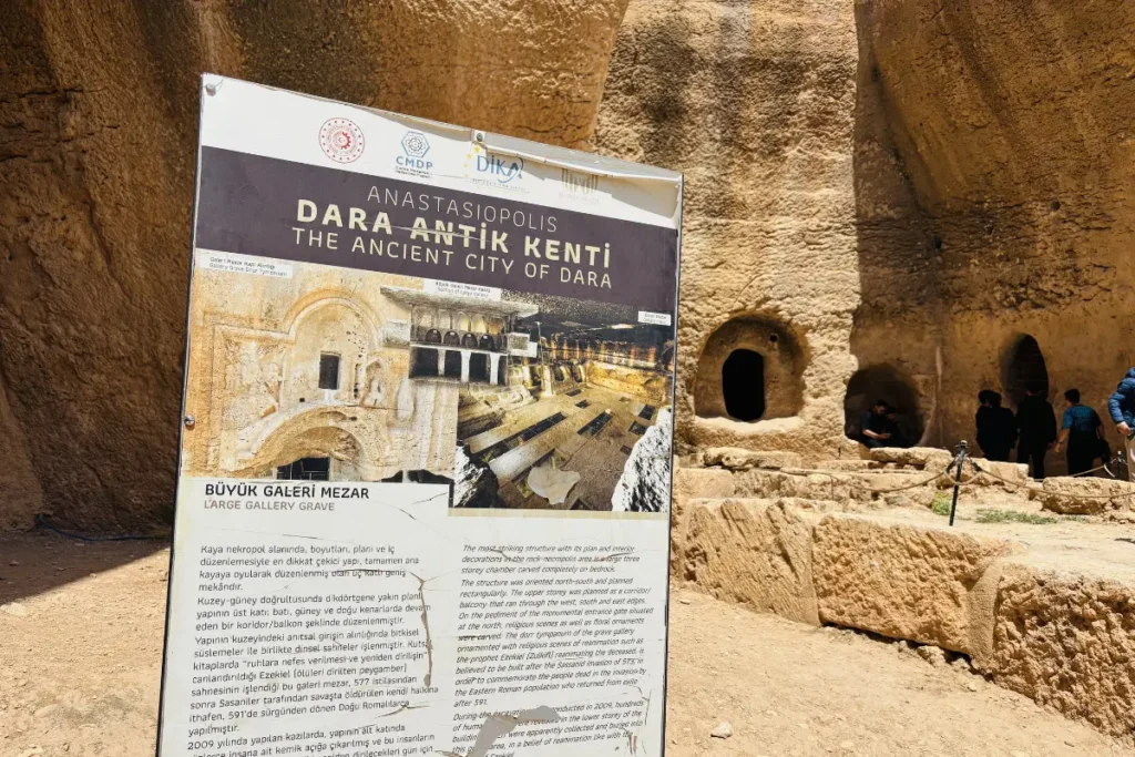 An information board with text and maps titled "Dara Antik Kenti" at the entrance of the Dara archaeological site.