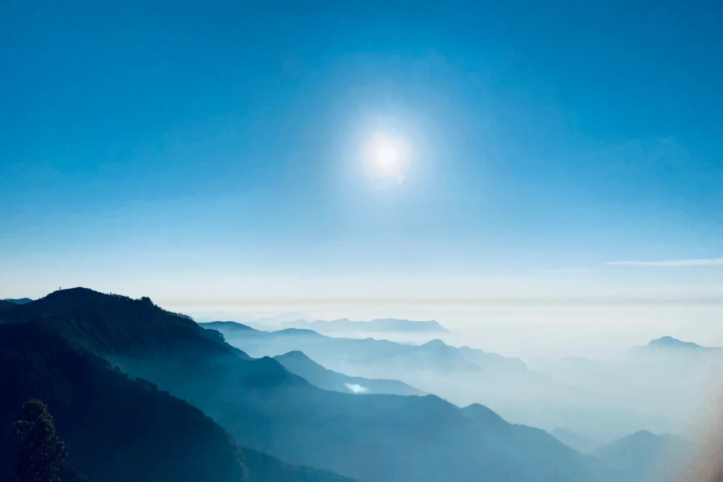 Steep rocky cliff at Dolphin's Nose viewpoint overlooking misty valley in Kodaikanal Tamil Nadu