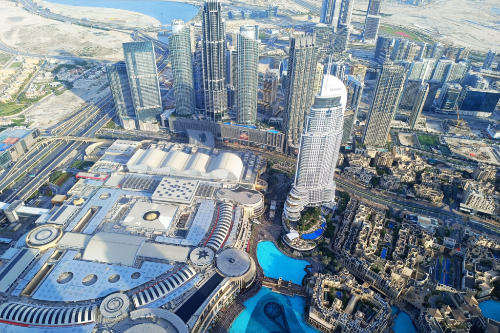 An aerial viewpoint overlooking a high-density urban landscape filled with intricate modern highways and soaring skyscrapers.