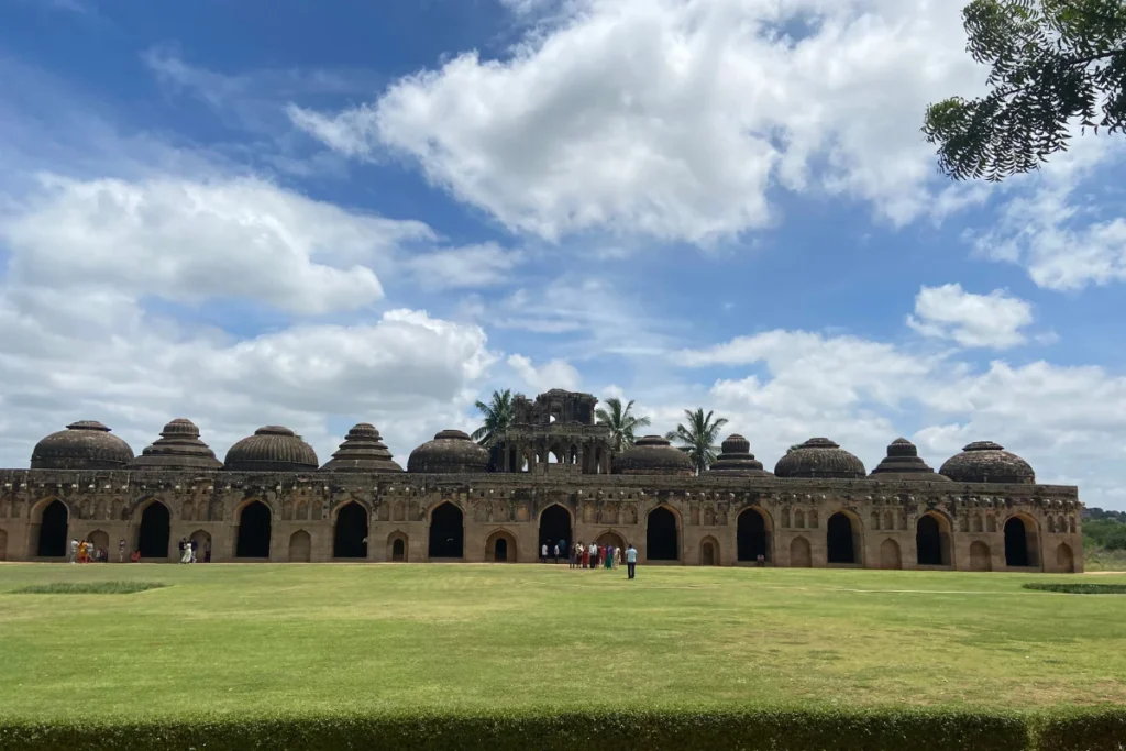 A wide exterior view of the long Elephant Stables building featuring a row of large, symmetrical arched openings and domes.