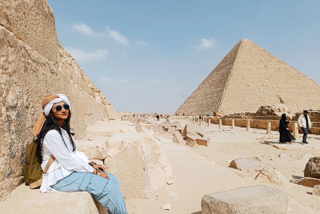 A close-up selfie of Sumana smiling in front of the Great Pyramid of Giza.