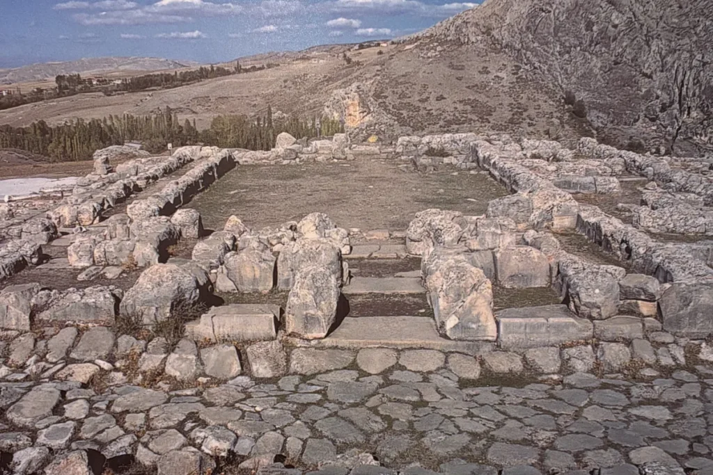 A high-angle view of the large, segmented stone foundations outlining the structure of the Great Temple.