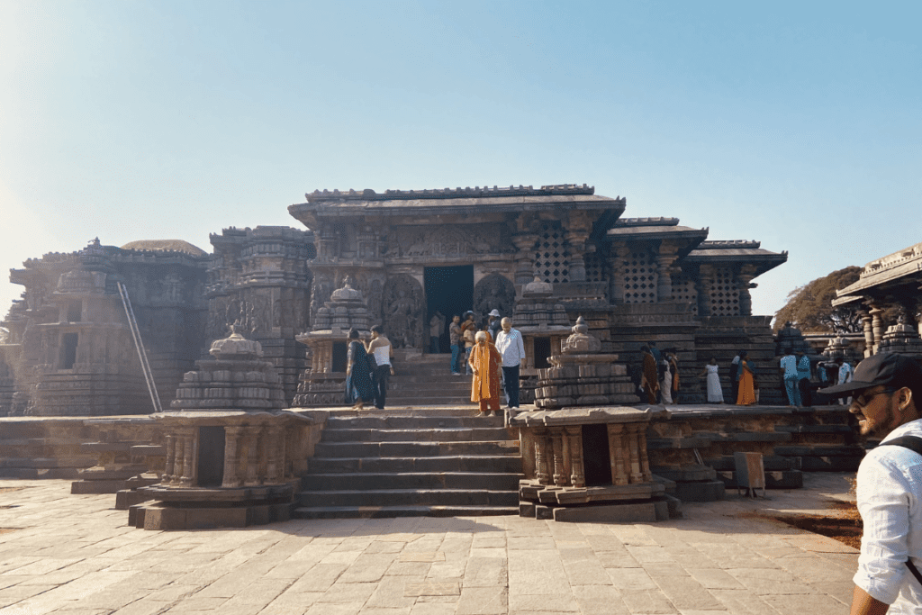 Hoysalashwara Temple A front-angle view of the Hoysaleshwara Temple entrance displaying its raised stone platform and detailed entrance architecture.