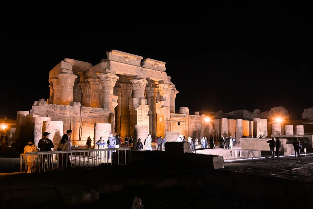 A night view of the ancient stone columns and ruins of the Temple of Kom Ombo.