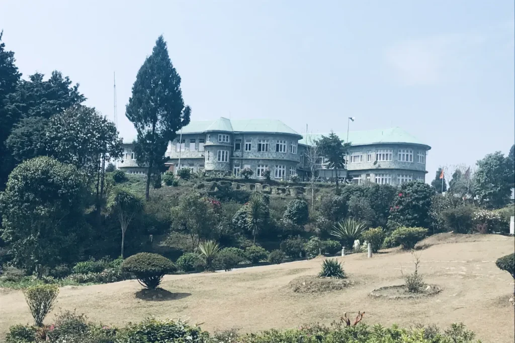 Colonial-era Delo House surrounded by dense trees Kalimpong West Bengal