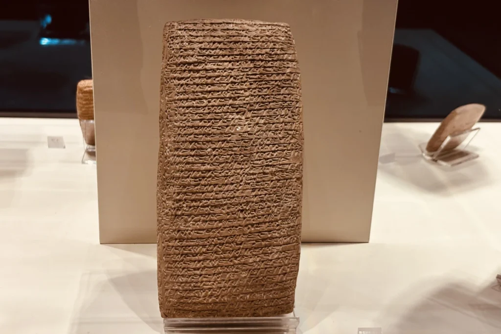 Close-up of an ancient, rectangular clay tablet inscribed with detailed cuneiform writing.