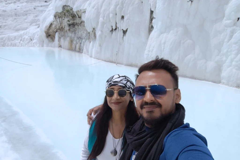 Akash & Sumana taking a close-up selfie together while visiting the white thermal travertine terraces.
