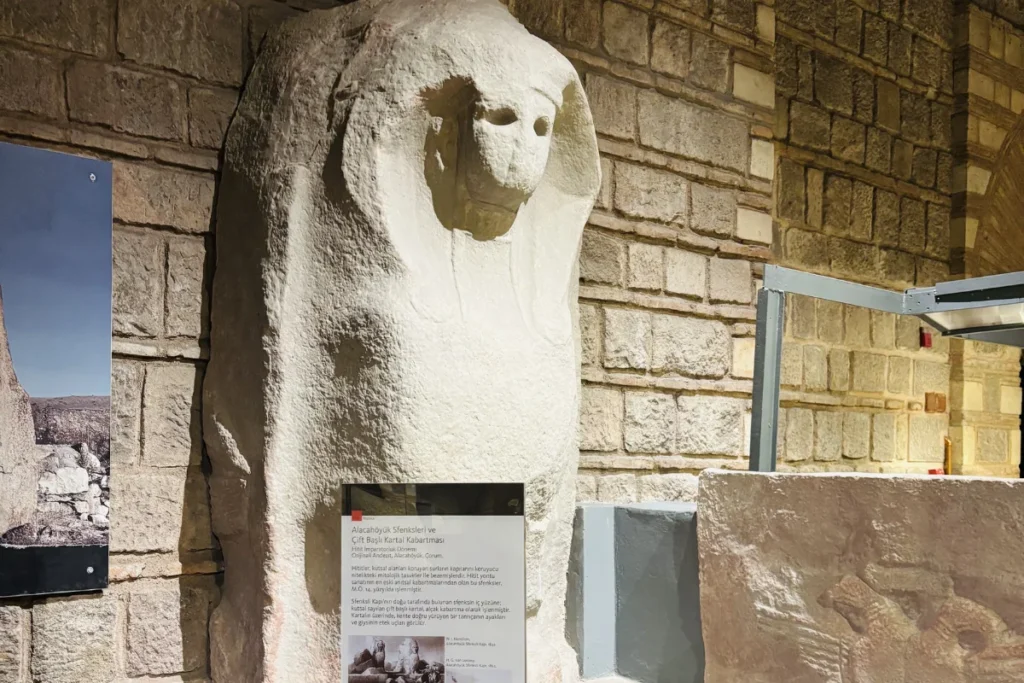 A carved stone sphinx acting as a monumental gate guardian inside the Museum of Anatolian Civilizations.