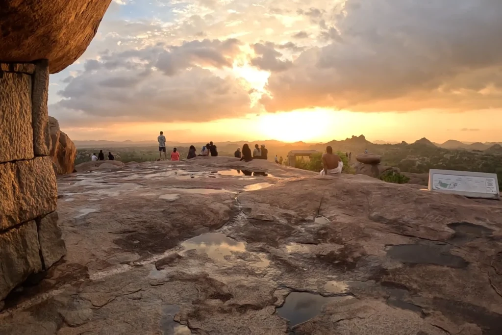 A beautiful sunset view captured through a natural rock arch framing the golden horizon over Malyavanta Hill.