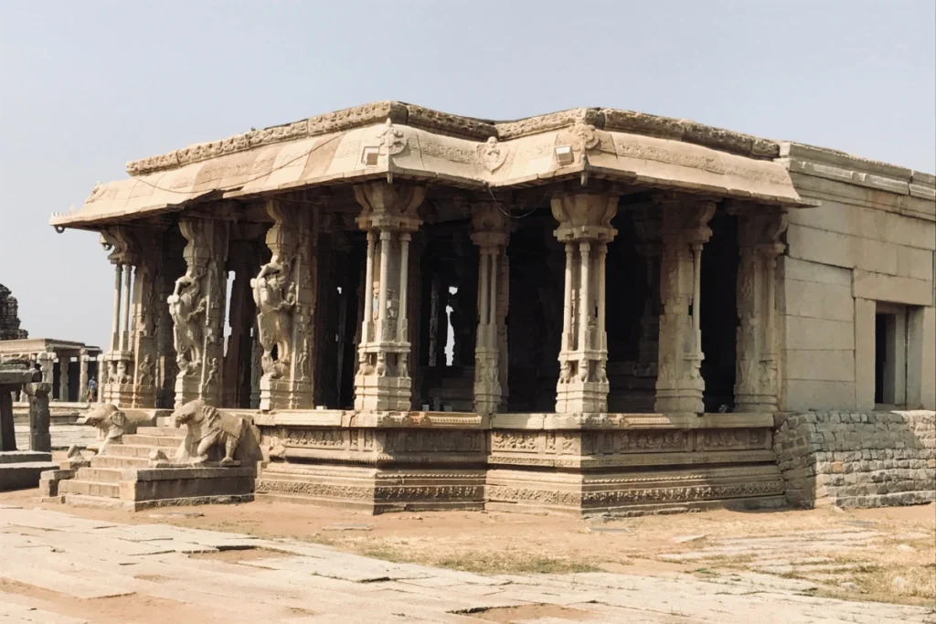 The stone ruins and carved pillars of the main hall at the famous Vittala Temple complex in Hampi.