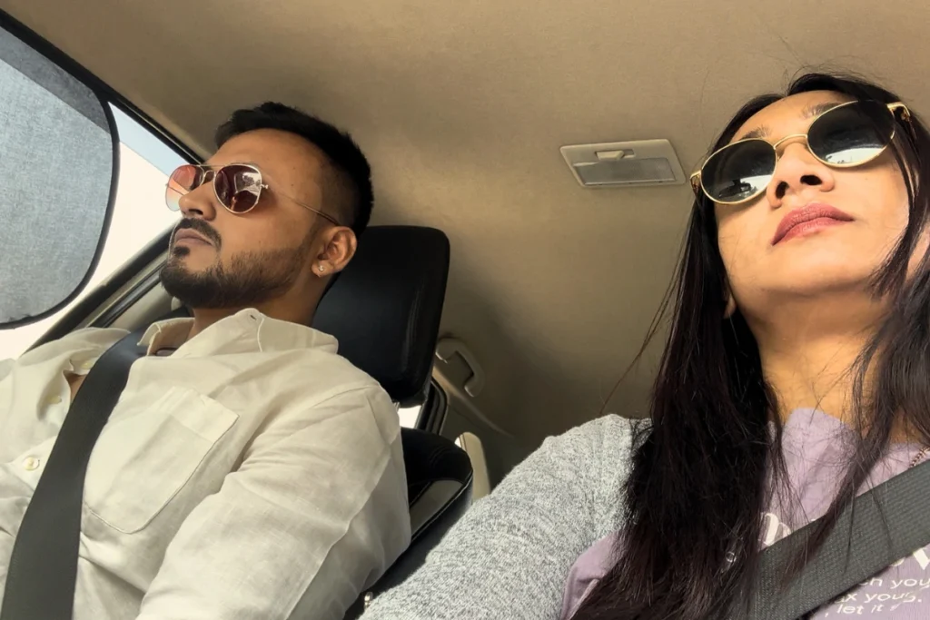 Akash & Sumana looking at the road ahead inside a moving car.