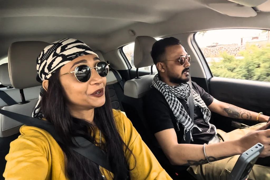 Akash & Sumana talking inside a car.