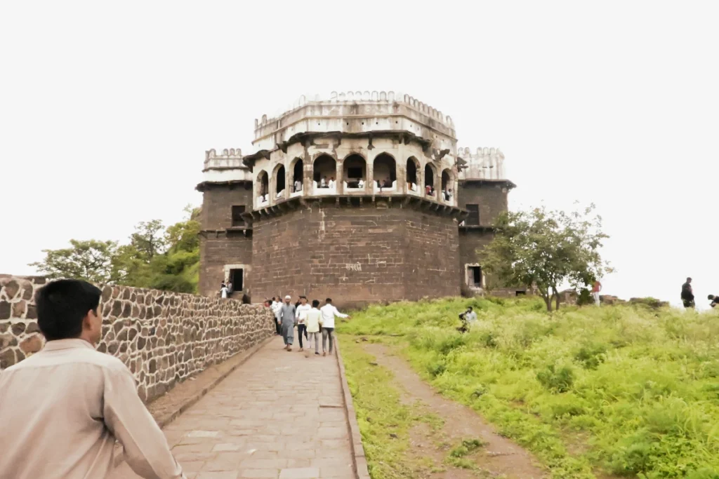 Daulatabad fort 3 Visitors walking up a stone pathway toward the multi-arched Baradari royal palace pavilion situated atop Daulatabad Fort.