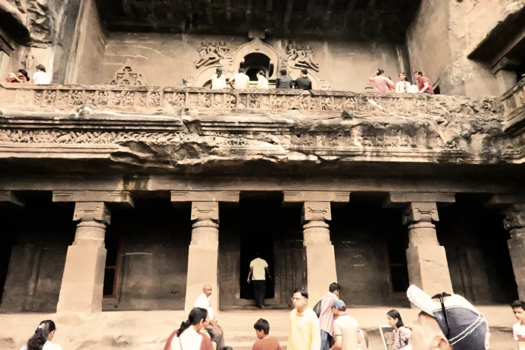 Ellora cave 1 The exterior architectural façade of Cave 10 at Ellora, showing large stone pillars, upper-level balconies, and a prominent Chaitya arched window.