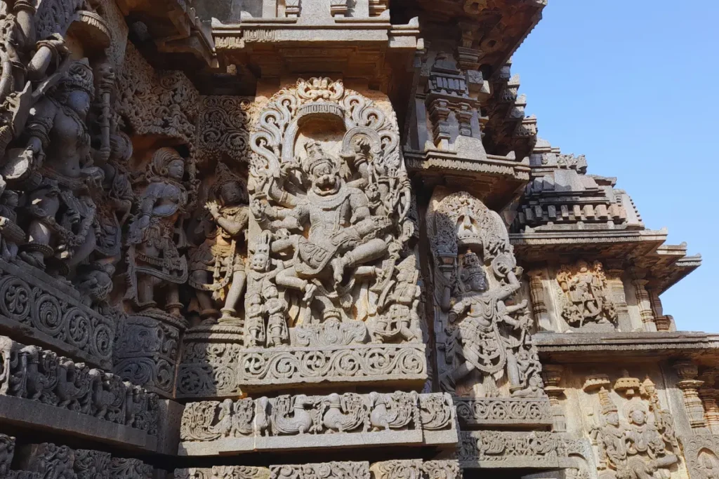 Hoysalaswar Temple 1 A ornate vertical stone relief carving depicting Hindu deities sculpted on the outer wall facade of Hoysaleshwara Temple.
