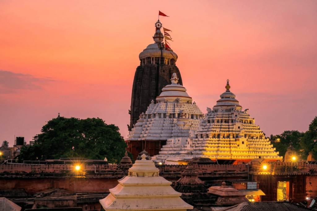JAGANATH TEMPLE 3 The towering spires of the Jagannath Temple lit up against a dark sky at dusk.
