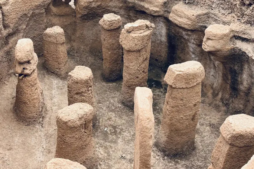 Karahan Tepe 8 A detailed view of a human face carved directly into the limestone wall of the excavated chamber at Karahan Tepe.