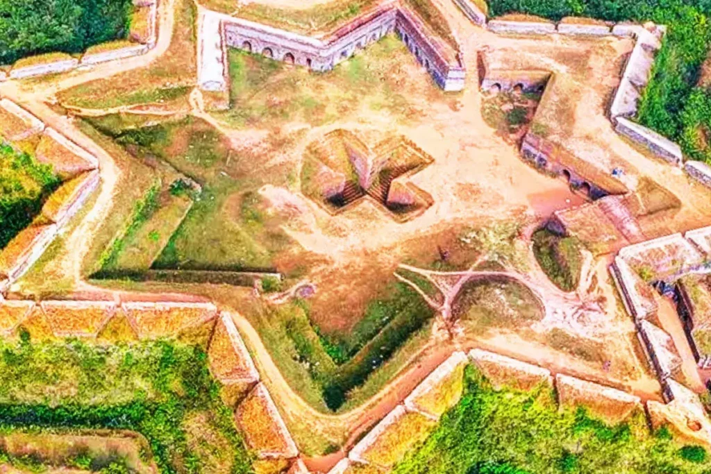 Manjarabad Fort 3 An aerial drone view showing the unique eight-pointed star shape of the stone walls and grassy ramparts of Manjarabad Fort.