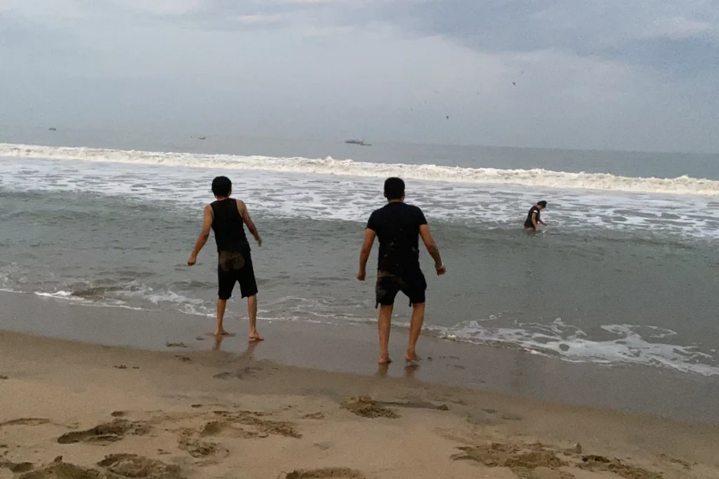 Pondicherry- Beach Time Akash & his friend enjoying the beach under an overcast sky.
