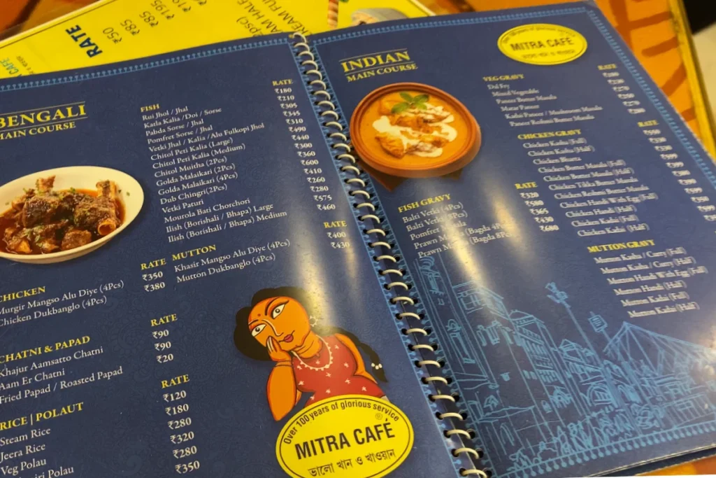 Puri Mitra Cafe A close-up view of a blue menu card from Mitra Cafe featuring various local and classic dishes.