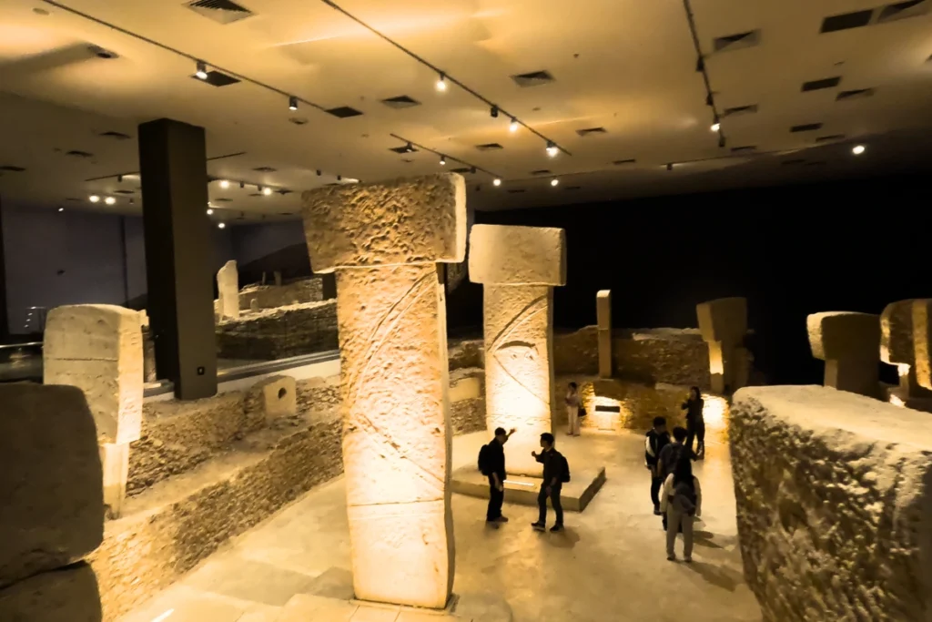 A full-scale replica room showcasing the circular arrangement of massive T-shaped stone pillars from Göbekli Tepe inside the museum.