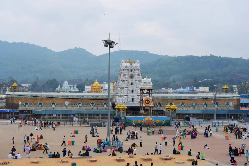 Tirupati- temple complex 4 A street-level shot showing a white gopuram spire rising above the surrounding town buildings and traffic.