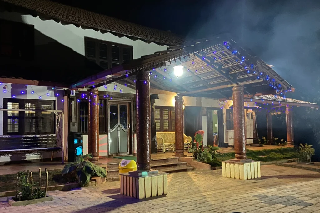 Chikmangalur An illuminated resort building with warm exterior lighting and modern wooden architecture at night in Chikmagalur.