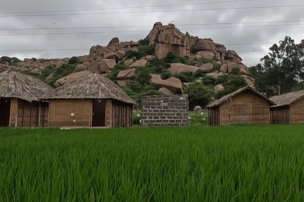 Hippi island 2 Thatched-roof resort cottages nestled at the base of giant, stacked natural granite boulder formations on Hippie Island.