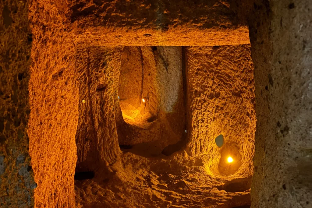 KAYMAKLI 2 A dimly lit, narrow stone corridor leading down into the subterranean chambers of Kaymaklı Underground City.