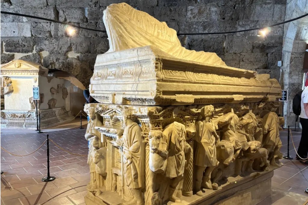 The Hierapolis Archaeological Museum 2 A side perspective of a large, detailed Roman stone sarcophagus inside the Hierapolis Archaeological Museum hall.