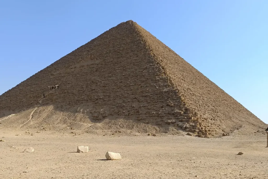 EGYPT- RED PYRAMID 1 Wide view of the large, smooth-sided Red Pyramid standing against a clear blue sky in the desert.