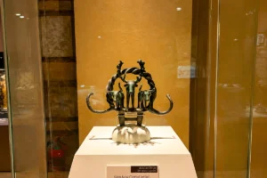Close-up of an intricate bronze ceremonial standard featuring bull and deer symbols displayed inside a glass case at the Museum of Anatolian Civilizations.