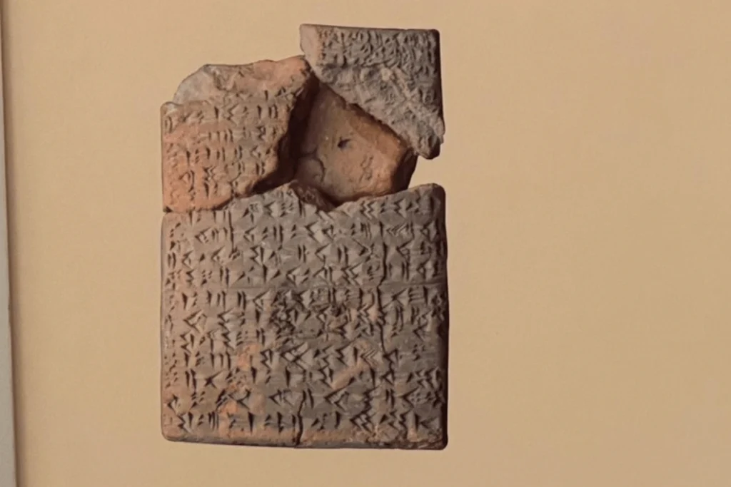 Close-up of a cuneiform clay tablet inscribed with ancient diplomatic text.