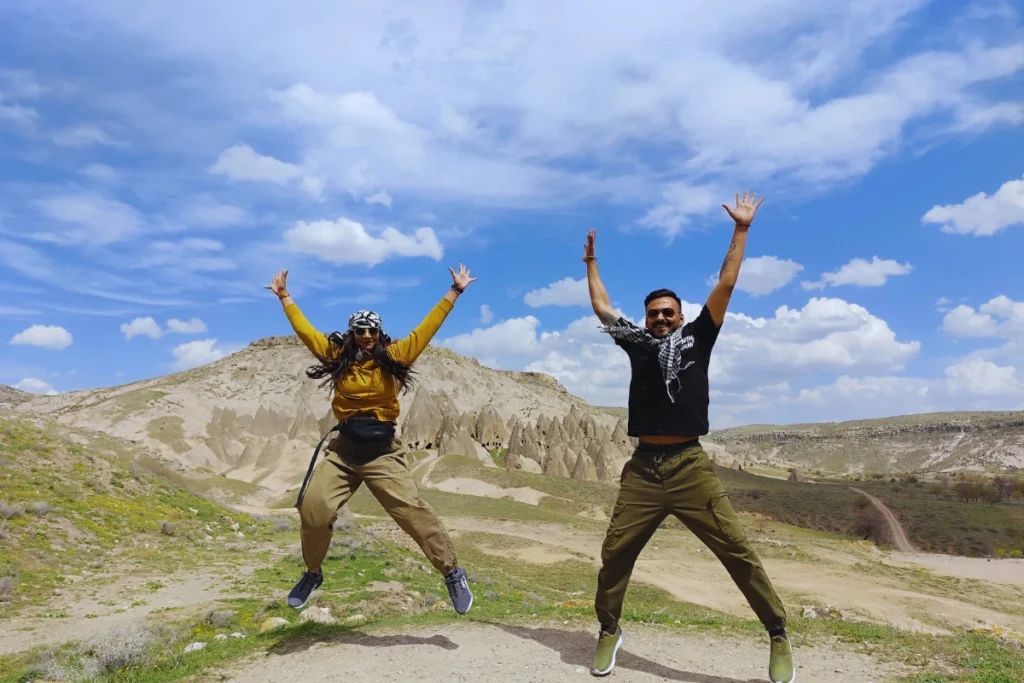 Selime Monastery6 Akash & Sumana captured mid-air in a high jump against a backdrop of surreal, pointy rock formations in Cappadocia.